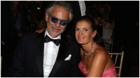 Andrea Bocelli in black tux with wife Veronica Berti at an event.